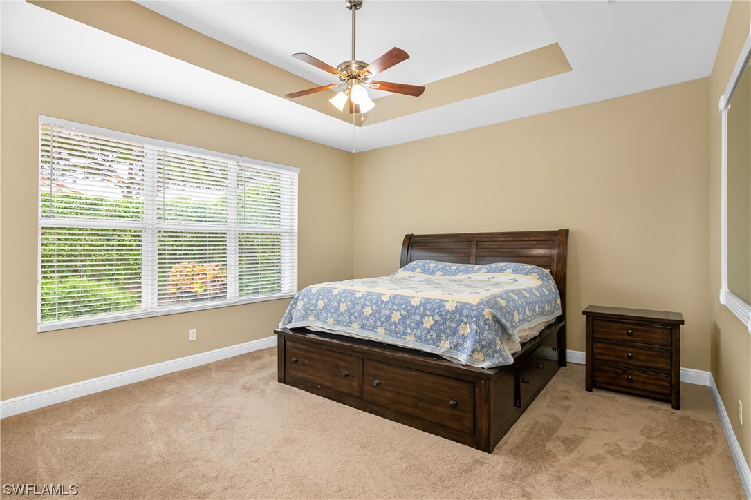 20524 Foxworth Circle Estero, FL 33928 - Photo 19 of 34 a spacious bedroom with a bed and a large window
