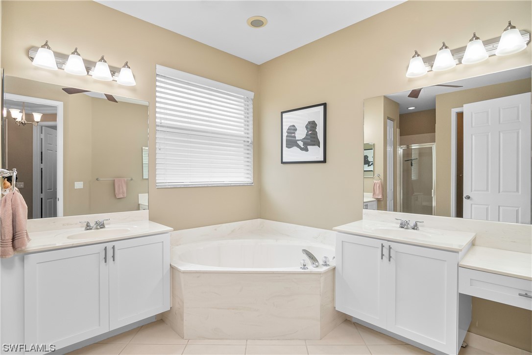 20524 Foxworth Circle Estero, FL 33928 - Photo 21 of 34 a bathroom with a tub a sink and a mirror