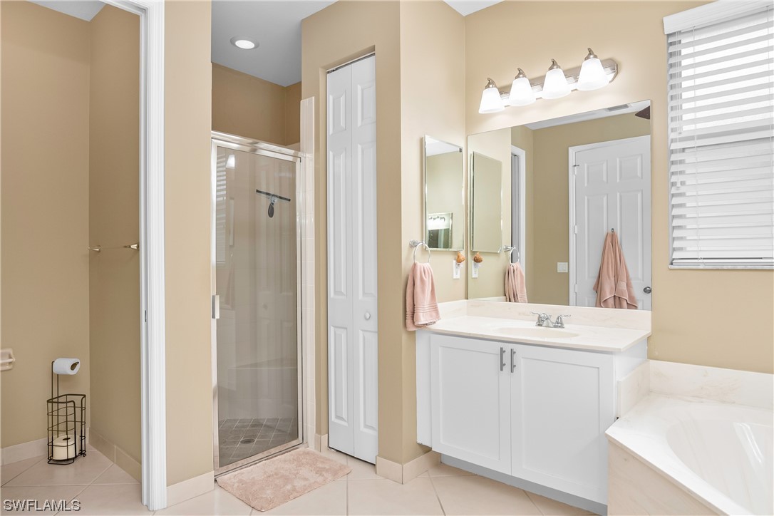 20524 Foxworth Circle Estero, FL 33928 - Photo 22 of 34 a bathroom with a sink vanity and a mirror
