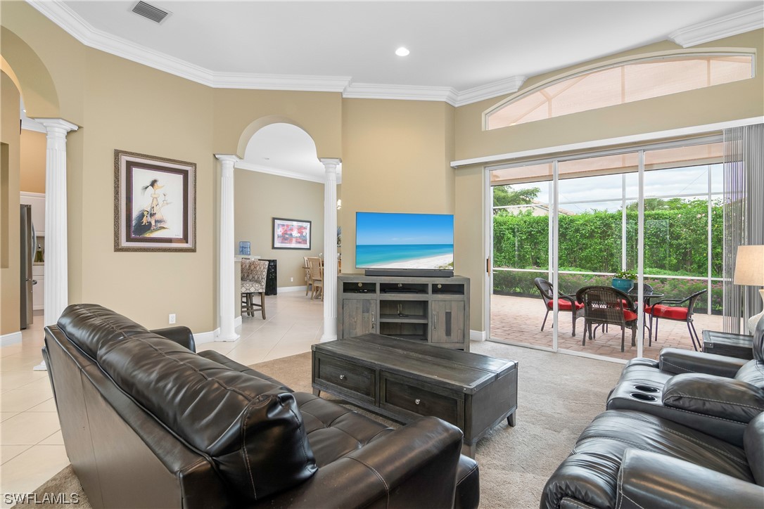 20524 Foxworth Circle Estero, FL 33928 - Photo 10 of 34 a living room with furniture a large window and a flat screen tv