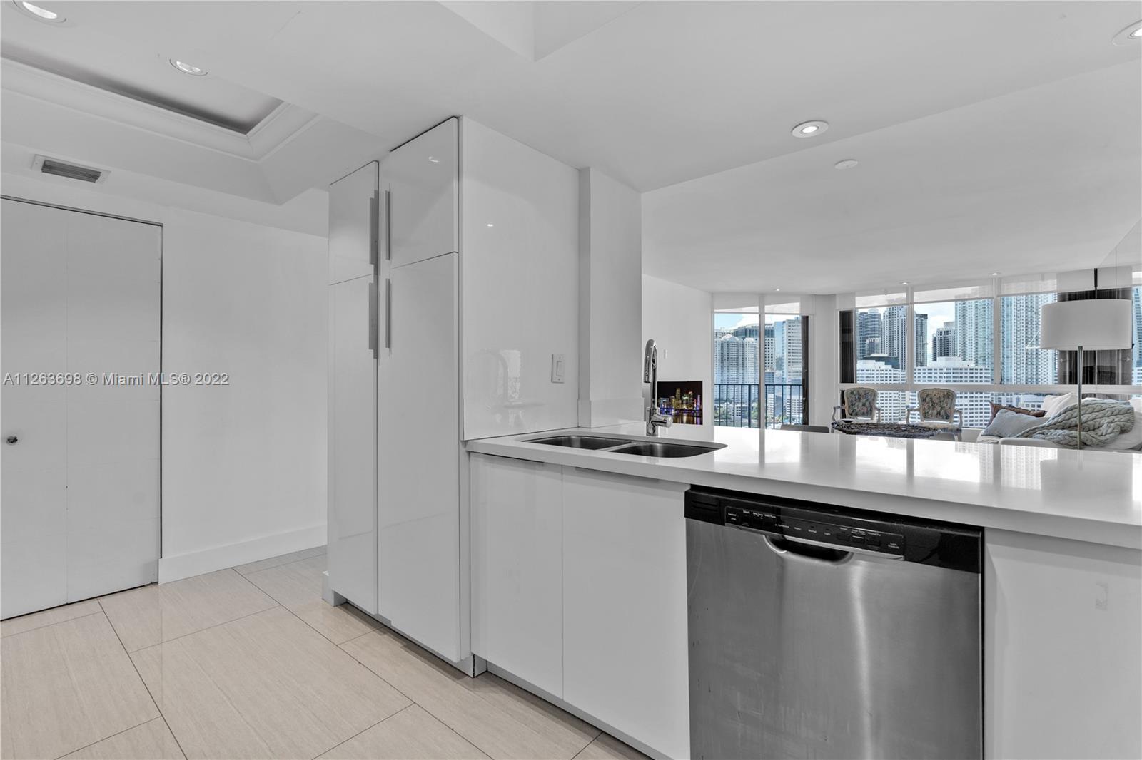 520 Brickell Key Drive, Unit A1819 Miami, FL 33131 - Photo 12 of 35 a kitchen with stainless steel appliances granite countertop a sink and cabinets