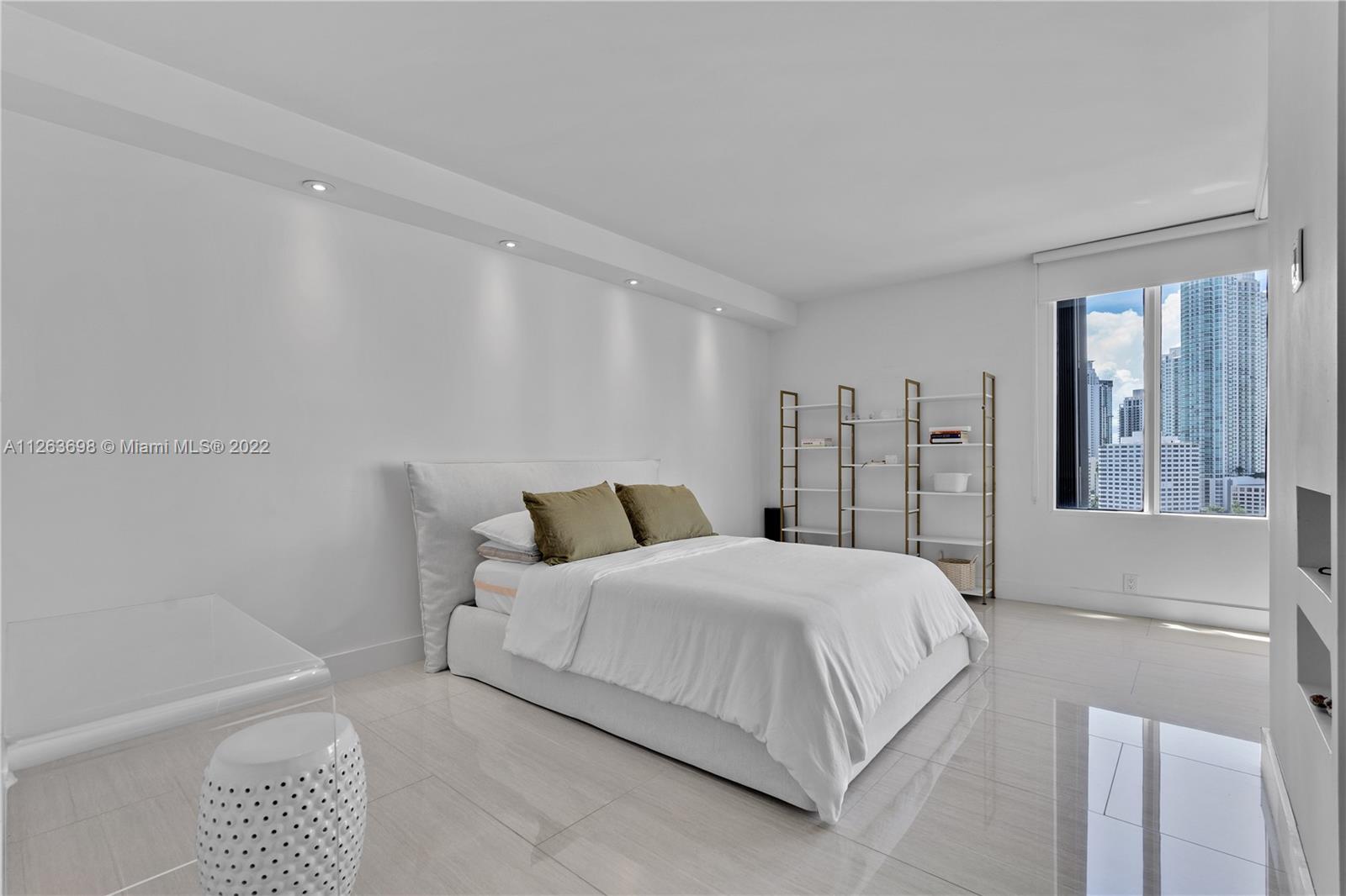 520 Brickell Key Drive, Unit A1819 Miami, FL 33131 - Photo 14 of 35 a bedroom with a bed and a large mirror