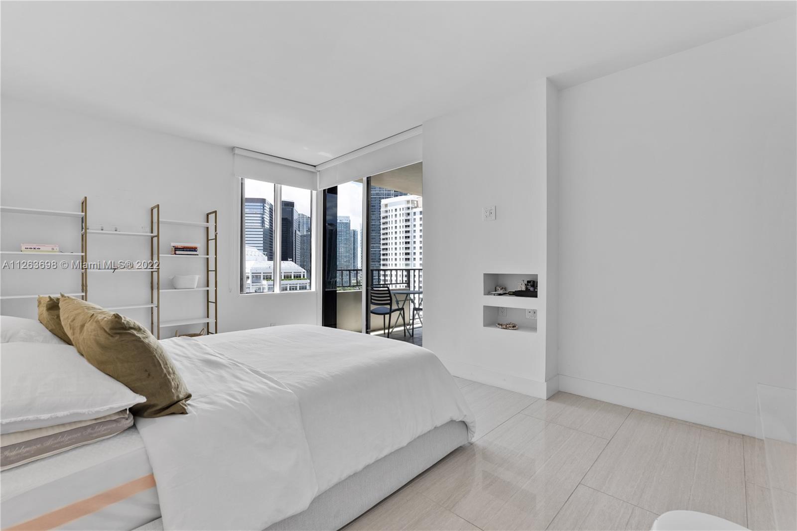 520 Brickell Key Drive, Unit A1819 Miami, FL 33131 - Photo 15 of 35 a large white bed in a white room