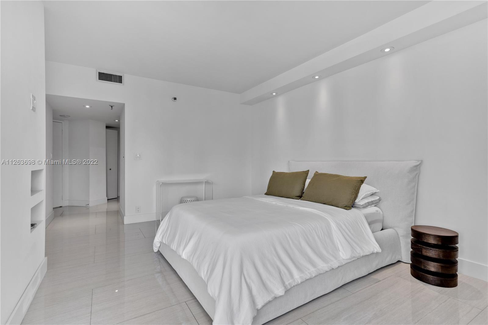 520 Brickell Key Drive, Unit A1819 Miami, FL 33131 - Photo 16 of 35 a bedroom with a bed and a walk in closet