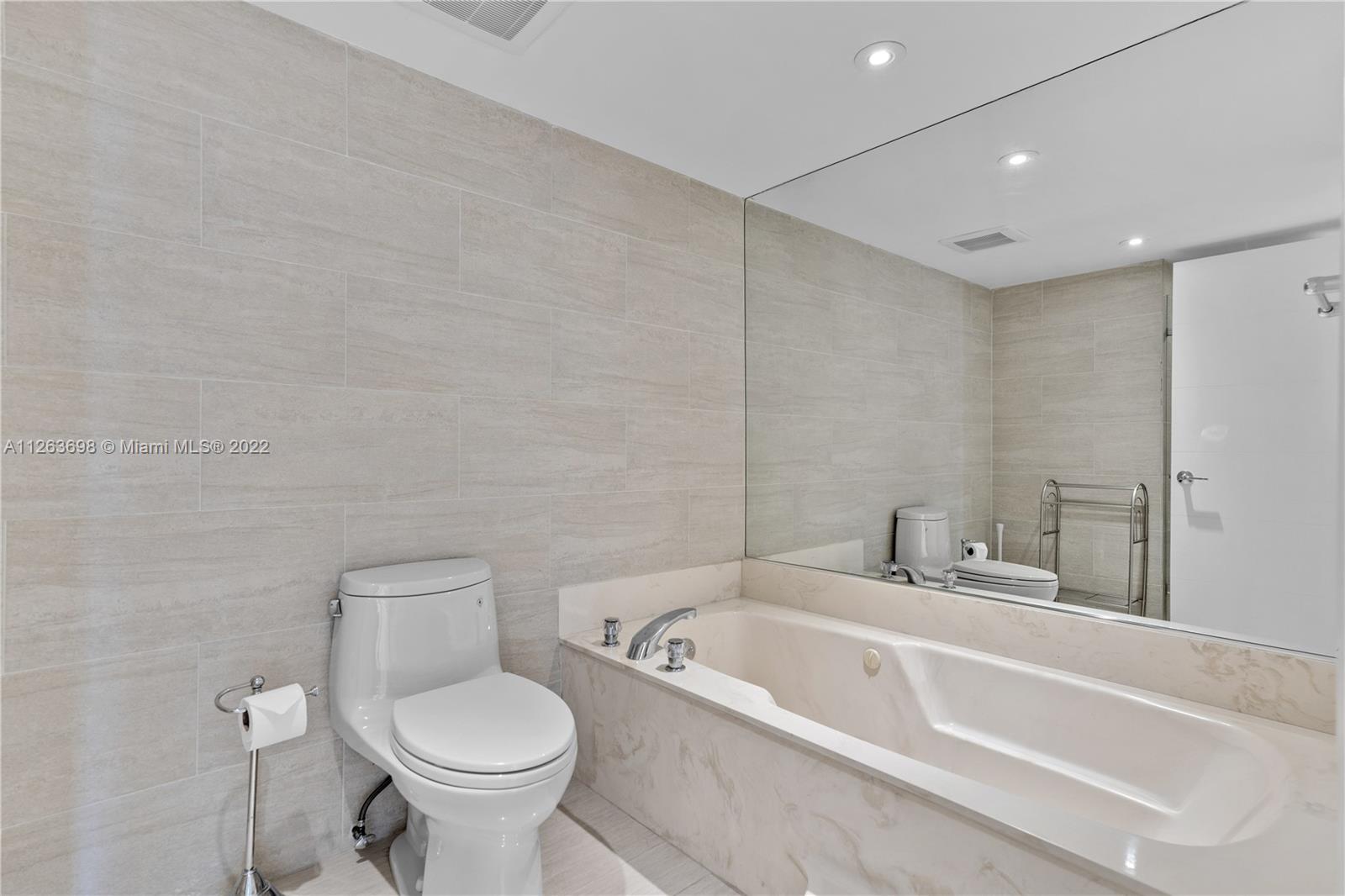 520 Brickell Key Drive, Unit A1819 Miami, FL 33131 - Photo 18 of 35 a bathroom with a toilet sink and mirror