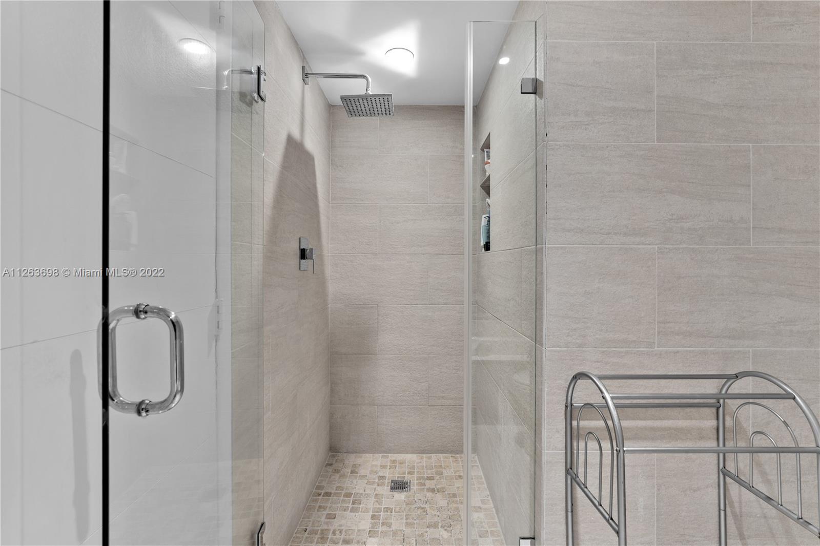 520 Brickell Key Drive, Unit A1819 Miami, FL 33131 - Photo 19 of 35 a bathroom with a shower and a mirror
