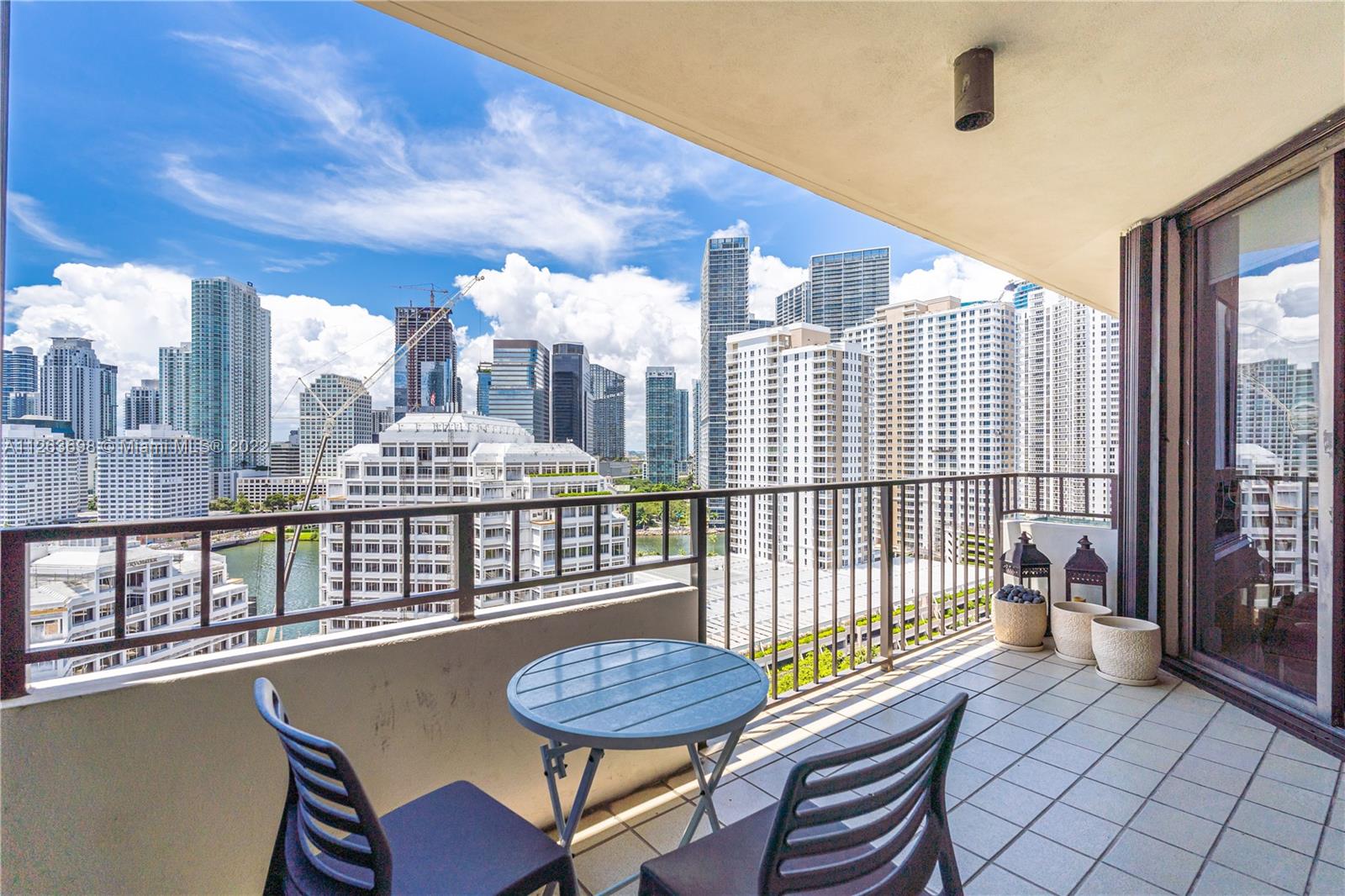 520 Brickell Key Drive, Unit A1819 Miami, FL 33131 - Photo 3 of 35 a living room with a table chairs and wooden floor