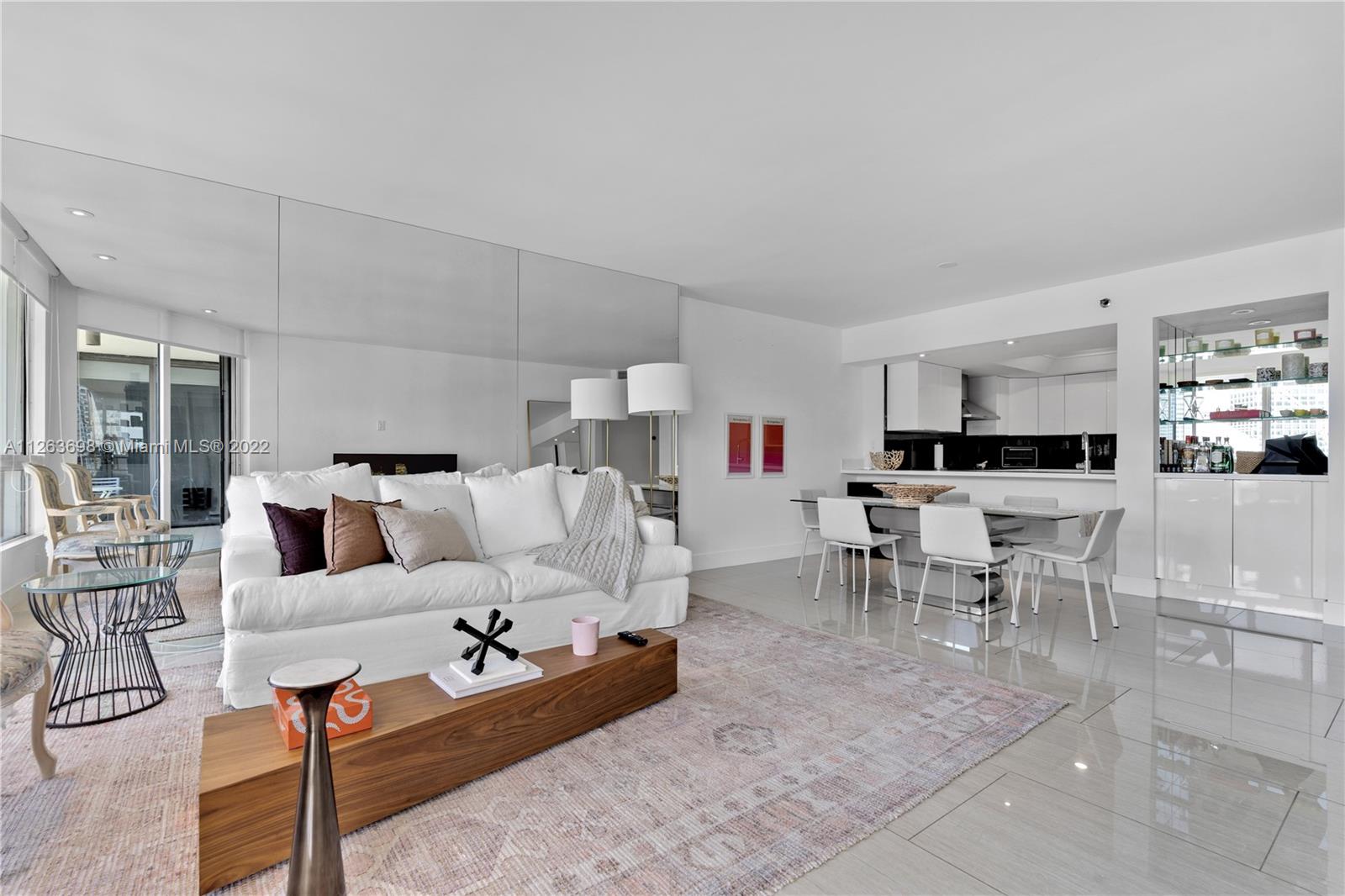 520 Brickell Key Drive, Unit A1819 Miami, FL 33131 - Photo 5 of 35 a living room with furniture kitchen view and a table