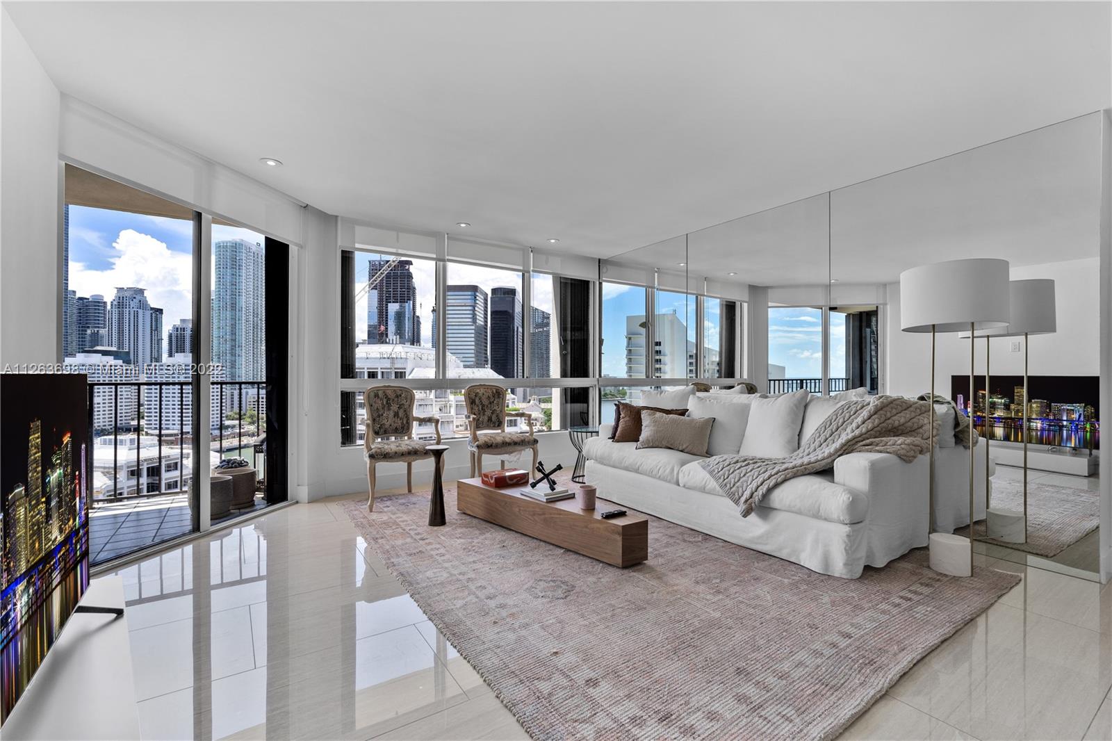 520 Brickell Key Drive, Unit A1819 Miami, FL 33131 - Photo 6 of 35 a living room with furniture and a lamp