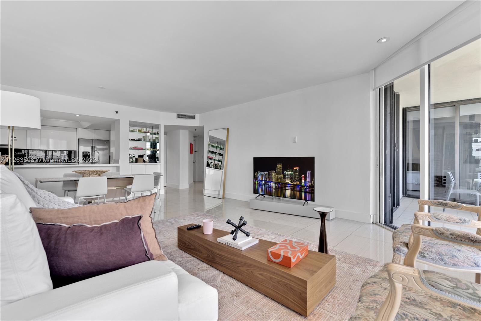 520 Brickell Key Drive, Unit A1819 Miami, FL 33131 - Photo 7 of 35 a living room with furniture and a flat screen tv