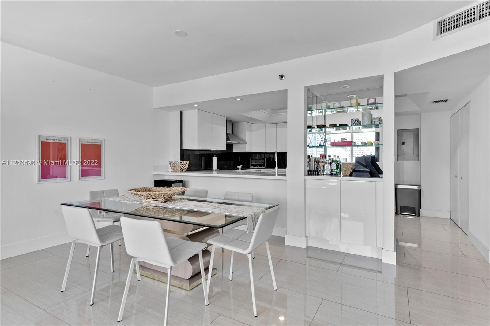 520 Brickell Key Drive, Unit A1819 Miami, FL 33131 - Photo 9 of 35 a kitchen with stainless steel appliances kitchen island granite countertop a table and chairs in it