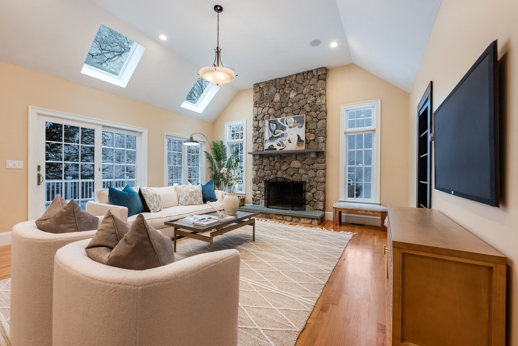 50 Barrett Street Needham, MA 02492 - Photo 11 of 32 a living room with furniture a flat screen tv and a fireplace