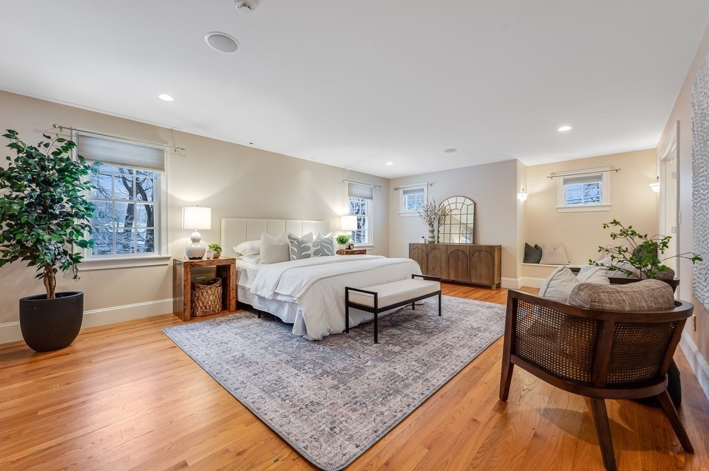 50 Barrett Street Needham, MA 02492 - Photo 17 of 32 a spacious bedroom with a bed a chandelier and potted plant