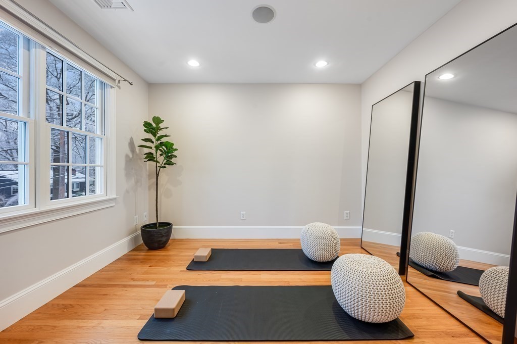 50 Barrett Street Needham, MA 02492 - Photo 18 of 32 a bedroom with furniture and a potted plant