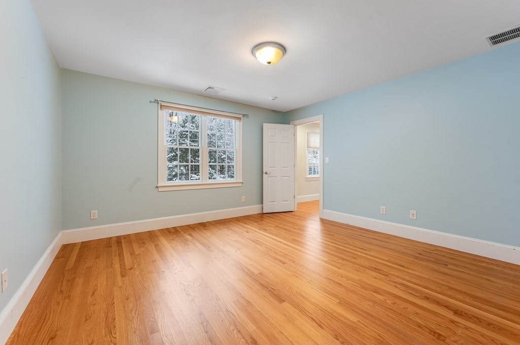 50 Barrett Street Needham, MA 02492 - Photo 23 of 32 an empty room with wooden floor and windows