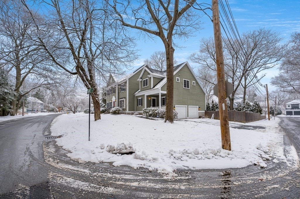 50 Barrett Street Needham, MA 02492 - Photo 28 of 32 a front view of a house with a yard covered in snow