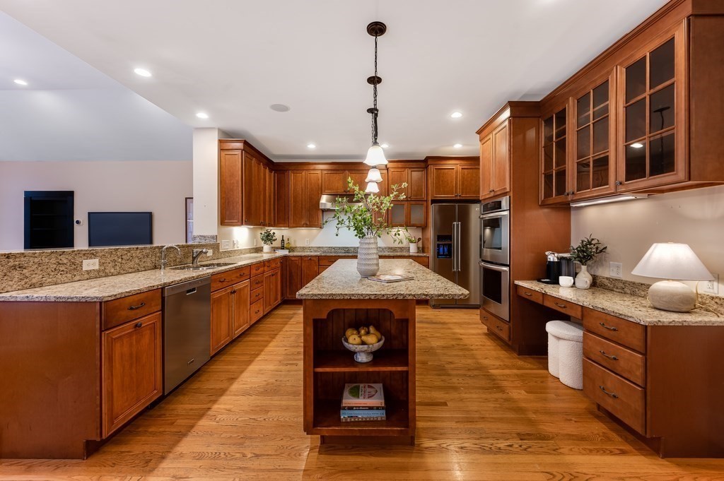 50 Barrett Street Needham, MA 02492 - Photo 7 of 32 a kitchen with stainless steel appliances granite countertop wooden cabinets a sink a stove and a refrigerator