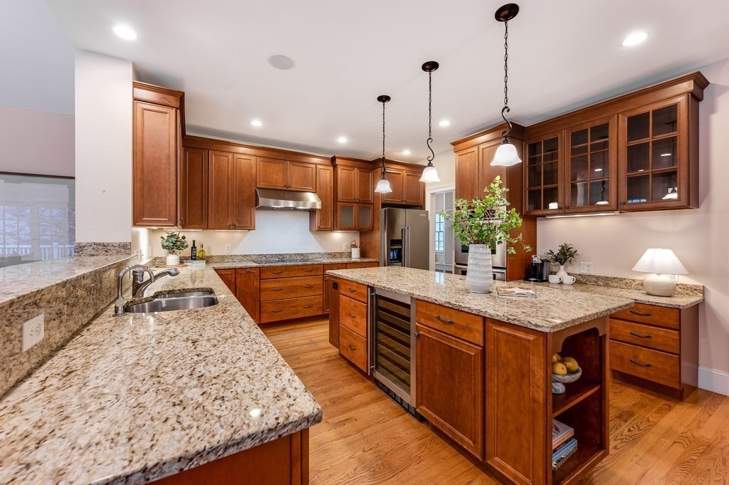 50 Barrett Street Needham, MA 02492 - Photo 8 of 32 a kitchen with stainless steel appliances granite countertop wooden cabinets a sink a stove and a wooden floors