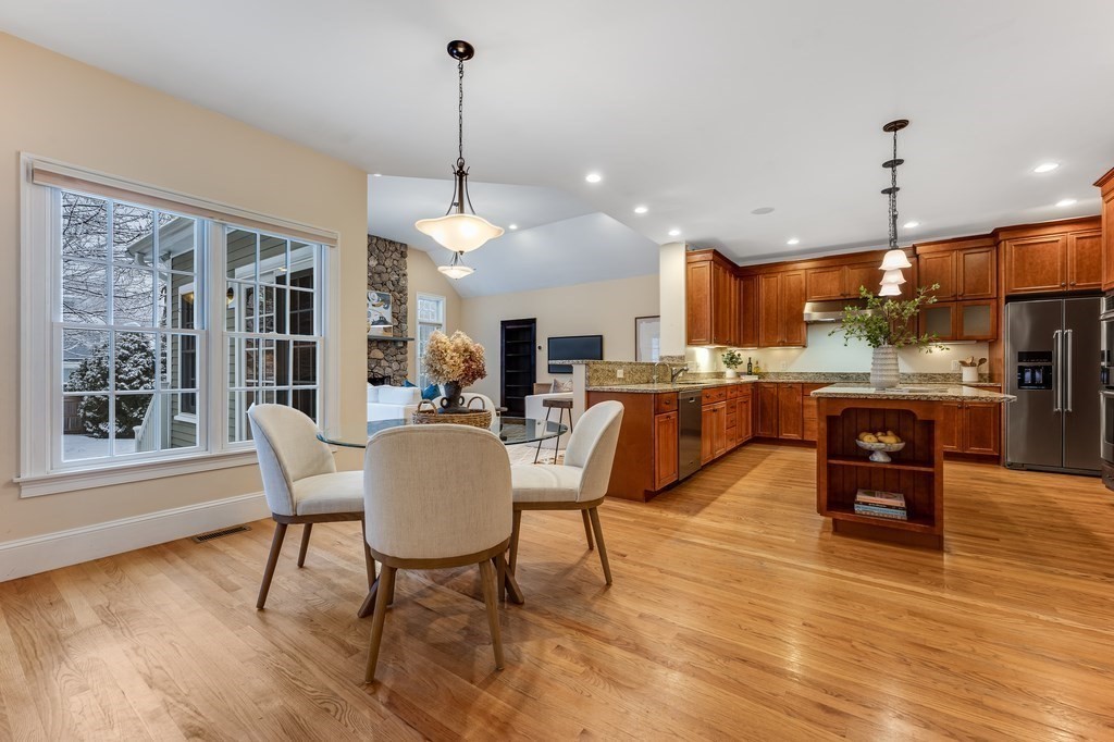 50 Barrett Street Needham, MA 02492 - Photo 9 of 32 a living room with couches a dining table chairs and kitchen view with wooden floor