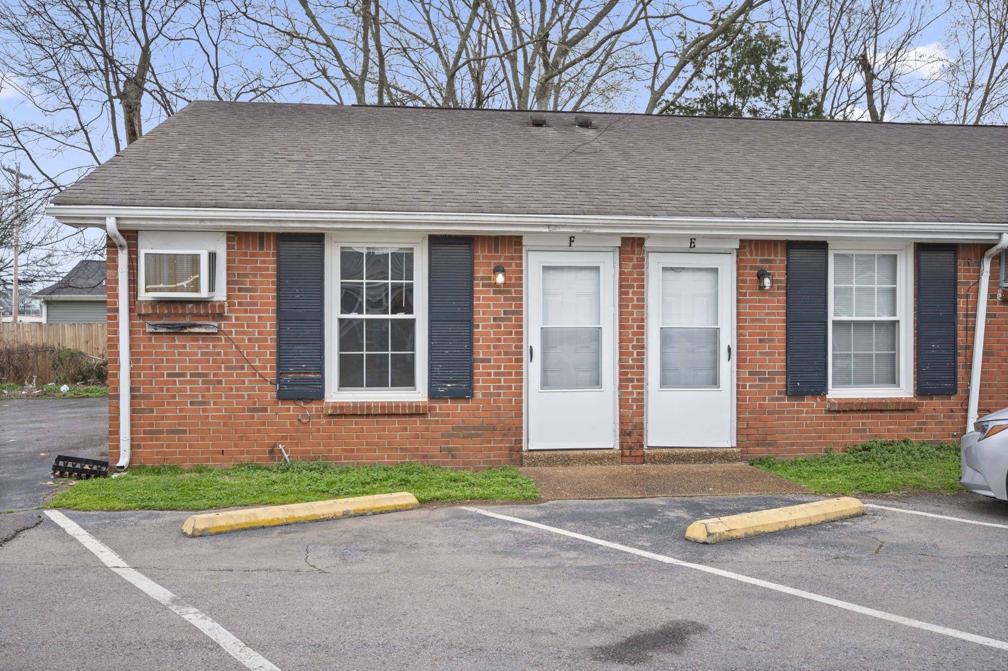 a front view of a house with a yard and a garage