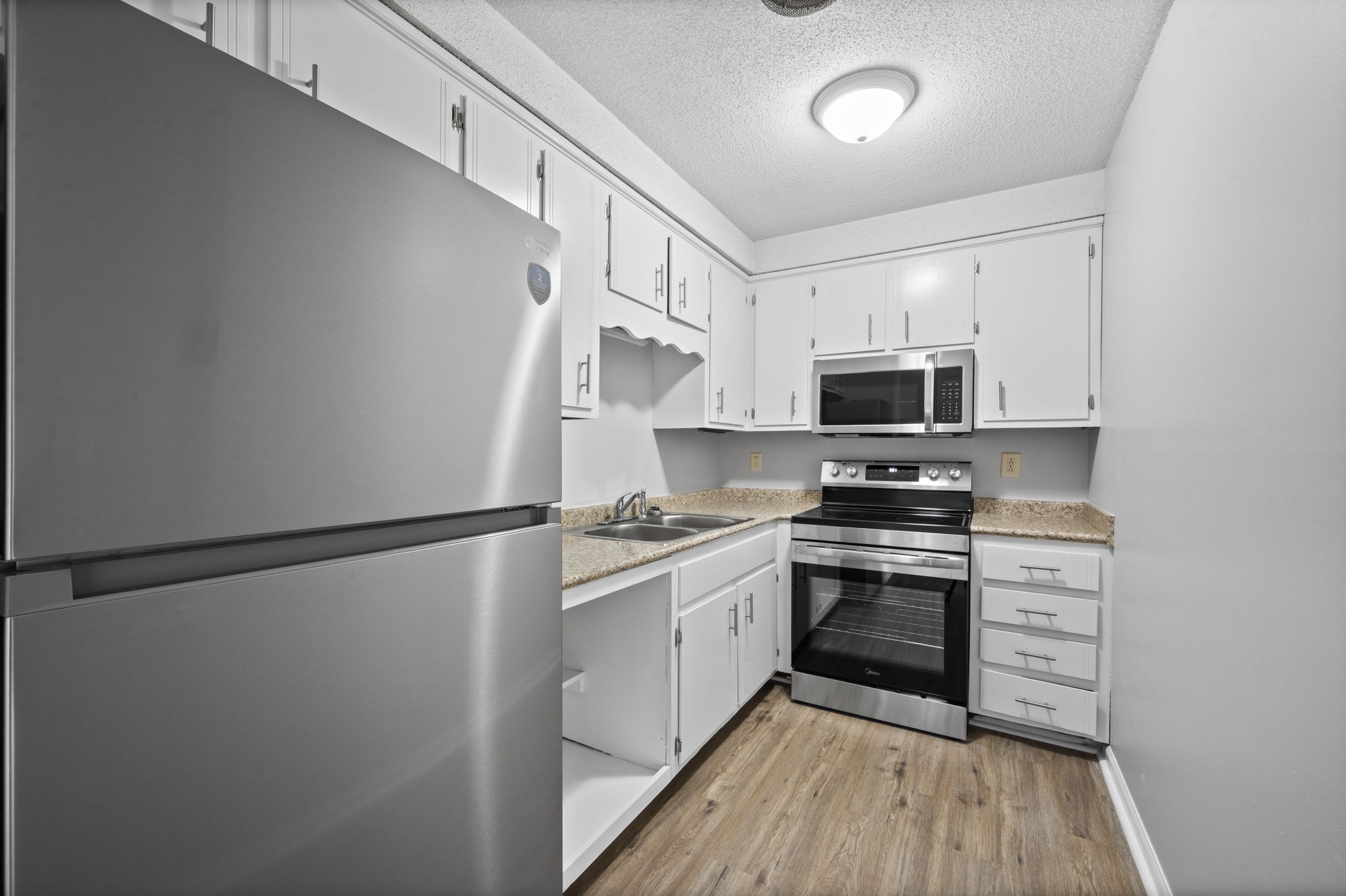 703 Power Street, Unit F Clarksville, TN 37042 - Photo 8 of 13 a kitchen with stainless steel appliances a refrigerator sink and microwave