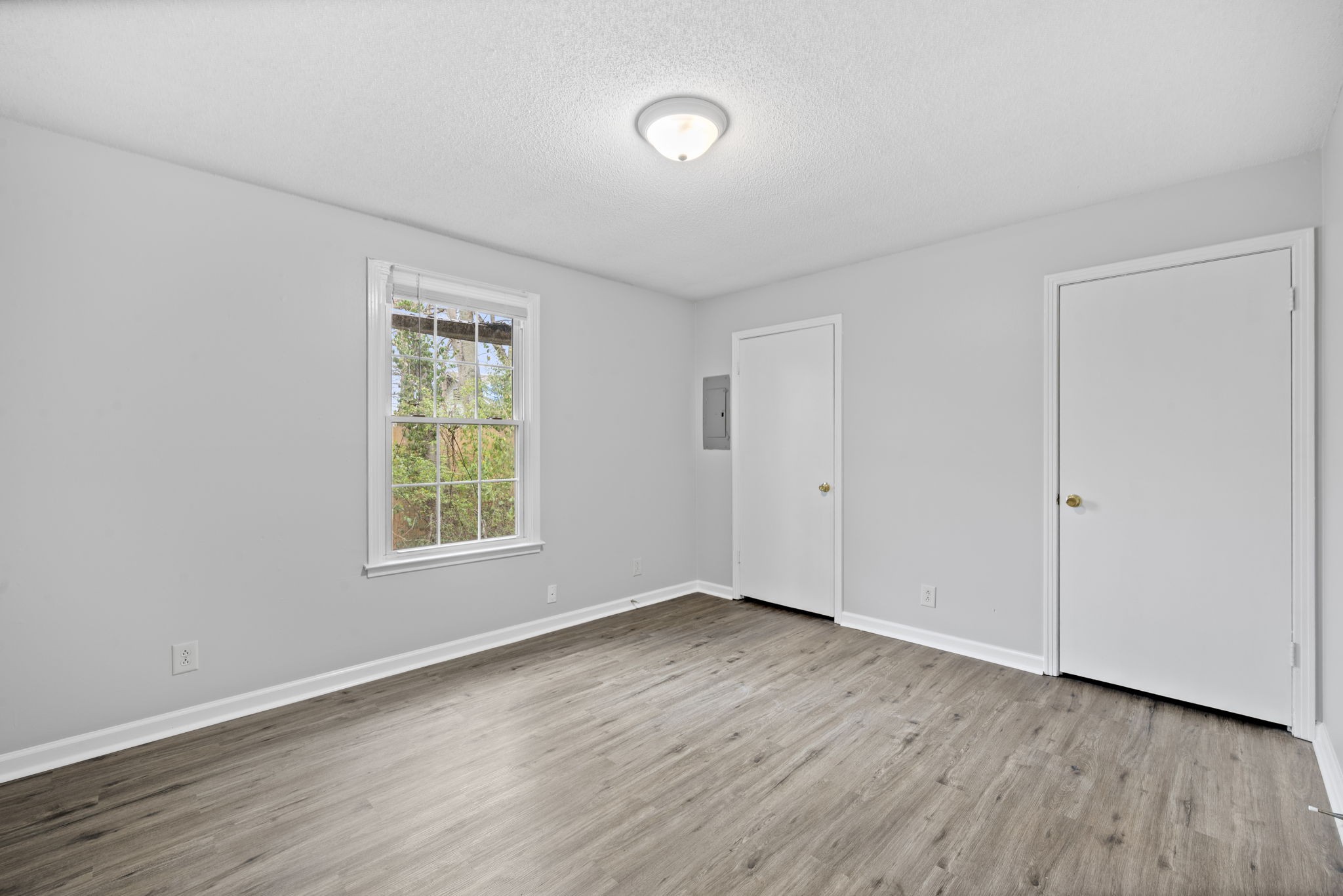 703 Power Street, Unit F Clarksville, TN 37042 - Photo 10 of 13 an empty room with wooden floor and windows