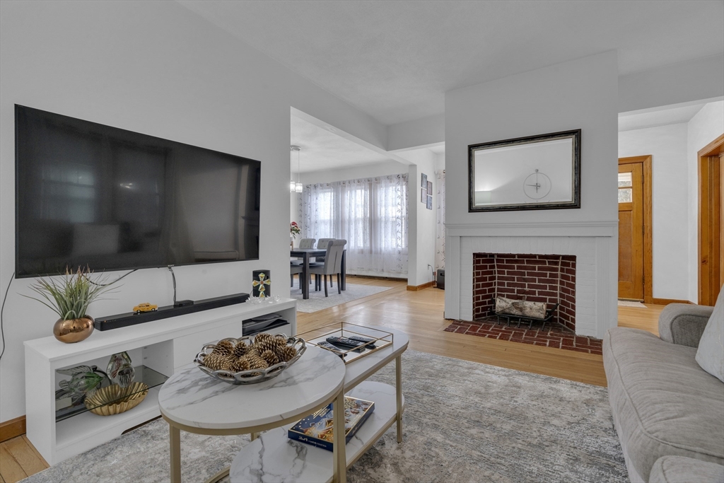 64 Commonwealth Road Watertown, MA 02472 - Photo 8 of 23 a living room with furniture and a flat screen tv