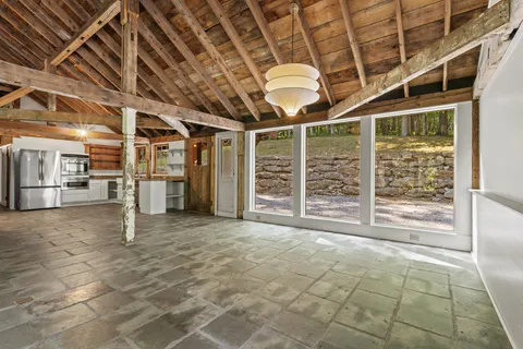 a kitchen with stainless steel appliances granite countertop a refrigerator and a stove top oven