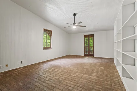 a view of an empty room with wooden floor