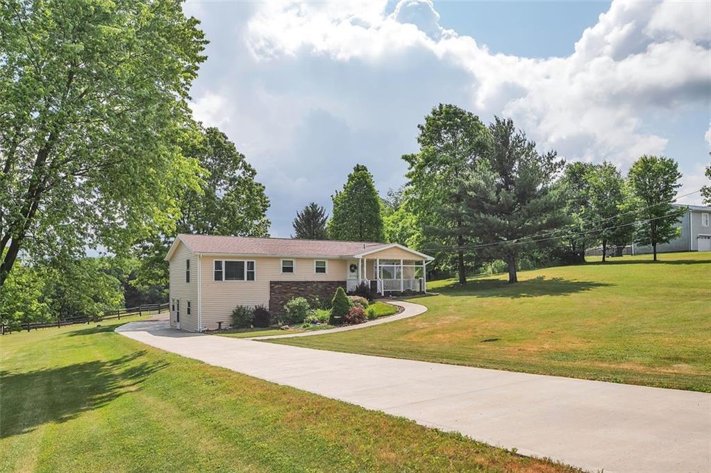 1201 Prospect Road Evans City, PA 16033 - Photo 3 of 45 a house view with swimming pool and trees in the background