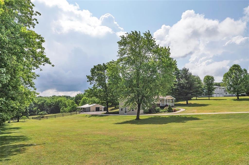 1201 Prospect Road Evans City, PA 16033 - Photo 4 of 45 a view of a swimming pool and trees in the background