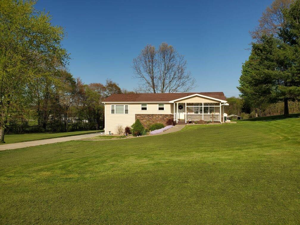 1201 Prospect Road Evans City, PA 16033 - Photo 44 of 45 a front view of a house with a yard