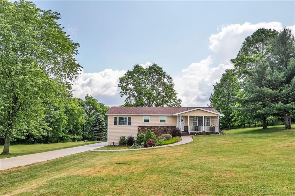 1201 Prospect Road Evans City, PA 16033 - Photo 5 of 45 a front view of a house with a garden