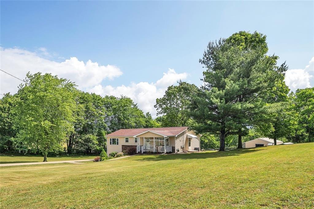 1201 Prospect Road Evans City, PA 16033 - Photo 6 of 45 a front view of a house with a yard and swimming pool
