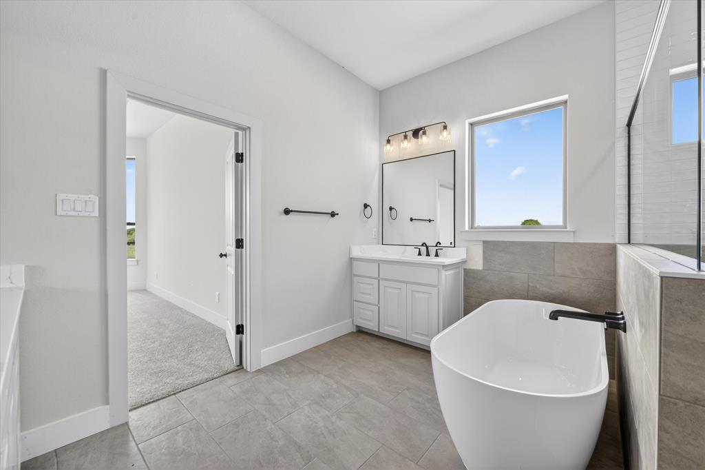 517 Longhorn Lane Springtown, TX 76082 - Photo 22 of 39 Full bath with vanity, a freestanding tub, light tile patterned flooring, and a walk in shower