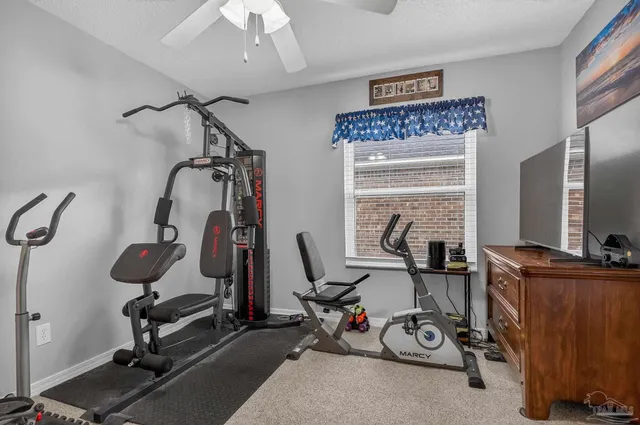 a bathroom with a toilet and shower curtain