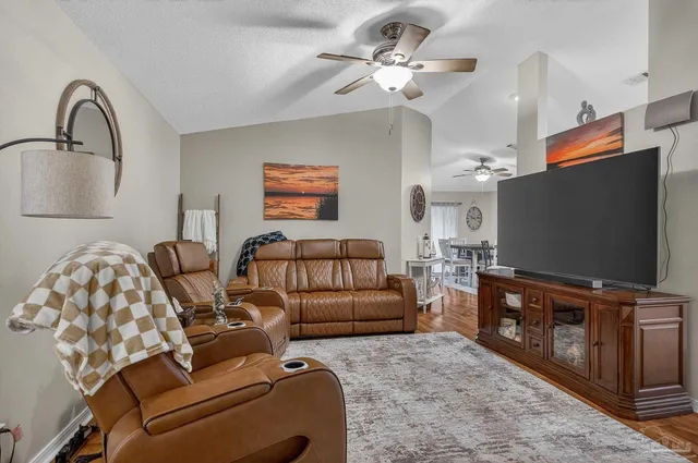 a living room with furniture and a flat screen tv