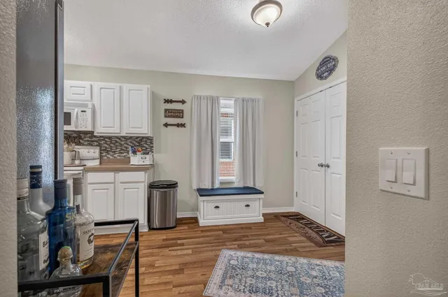 a view of a livingroom with wooden floor and cabinet