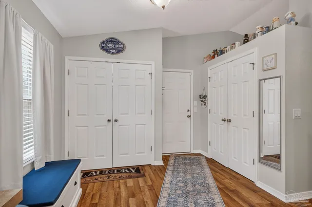 a kitchen with a stove and a wooden floor