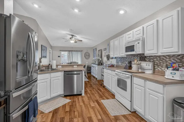 a kitchen with a refrigerator and a sink