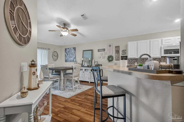 a view of a dining room with furniture and wooden floor