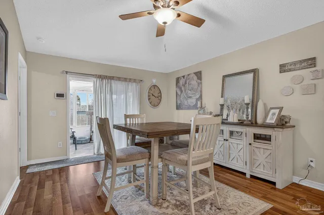 a view of a dining room with furniture and a chandelier