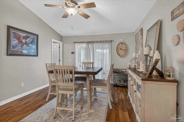 a view of a dining room with furniture and wooden floor