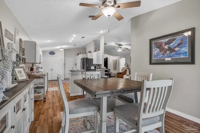 a view of a hallway with a livingroom and a chair