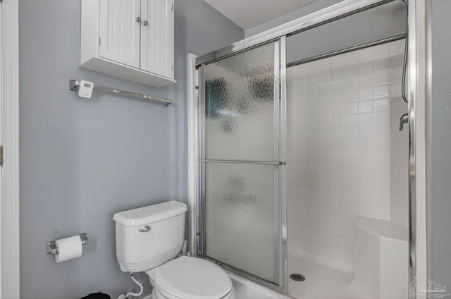 a spacious bedroom with a bed and dresser