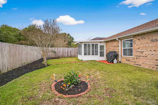 a backyard of a house with table and chairs