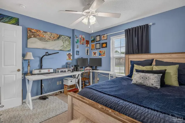 a spacious bedroom with a bed and a table