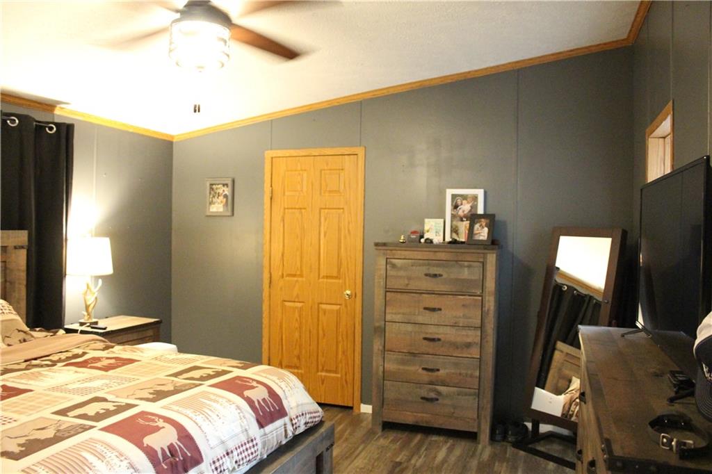 239 Smola Road Sandy Lake, PA 16145 - Photo 23 of 34 a bedroom with a bed and a mirror on the dresser