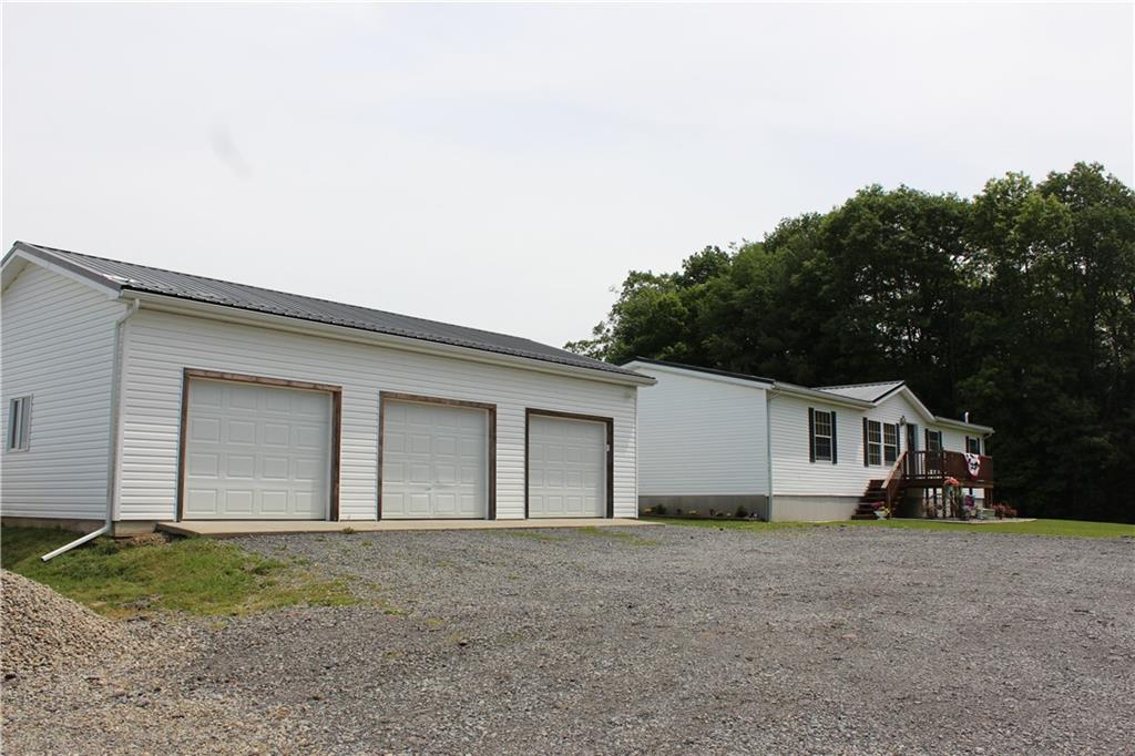 239 Smola Road Sandy Lake, PA 16145 - Photo 33 of 34 a view of a white house with a yard