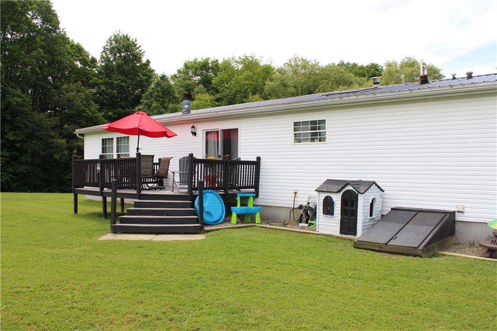 239 Smola Road Sandy Lake, PA 16145 - Photo 5 of 34 a view of a house with a chairs and table in the patio